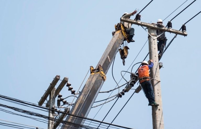 selective-focus-electricians-are-fixing-power-transmission-line-electricity-pole-1